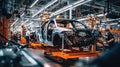 A mechanic in a car factory is installing engines for cars on the production line inside the factory