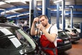 mechanic in a car repair shop inspected the condition of the windscreen wiper for wear and tear to ensure safety