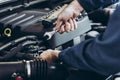Mechanic Car Service Man is Working in Garage Workshop, Technician Automotive is Inspection Checking Mechanical Car Engine and Royalty Free Stock Photo