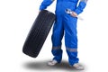 Mechanic carrying a tire and wrench Royalty Free Stock Photo