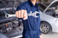 The mechanic is carrying the tools in the garage and is ready to provide service Royalty Free Stock Photo