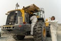 A mechanic changes the filter in a Komatsu loader during service.