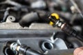 Mechanic changing broken car spark plugs. Royalty Free Stock Photo
