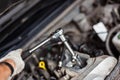 Mechanic changing broken car spark plugs. Royalty Free Stock Photo