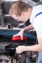 Mechanic changing car oil Royalty Free Stock Photo
