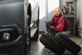 Mechanic changing a car tire in a workshop on a vehicle on a hoist using an electric drill to loosen the bolts in a concept of Royalty Free Stock Photo