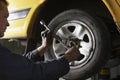 Mechanic Changing A Car Wheel In Garage Royalty Free Stock Photo