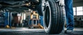 The mechanic changing a tire in a modern auto repair workshop. AI generated image Royalty Free Stock Photo