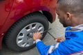 Mechanic Changing Tire With Wrench