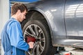 Mechanic Changing Wheel On Car With Pneumatic Wrench Royalty Free Stock Photo