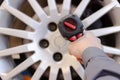 Mechanic changing wheel on car with a wrench Royalty Free Stock Photo