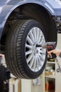 Mechanic changing wheel on car with a wrench Royalty Free Stock Photo