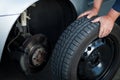 Mechanic changing a wheel of a modern car Royalty Free Stock Photo