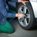 Mechanic changing a wheel of a modern car Royalty Free Stock Photo