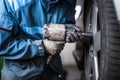 Mechanic changing a wheel of a modern car Royalty Free Stock Photo