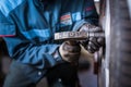 Mechanic changing a wheel of a modern car Royalty Free Stock Photo