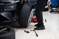 Mechanic changing wheel and tire. Car service Royalty Free Stock Photo