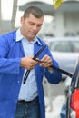 Mechanic changing windshield wiper blades on car