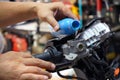 Mechanic Check and Add Brake Fluid on Motorcycle brake reservoir in garage, motorcycle maintenance and service and repair concept Royalty Free Stock Photo