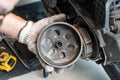 Mechanic check auto Transmission system or Rear Clutch Pulley of  scooter Motorcycles in garage. maintenance, repair motorcycle Royalty Free Stock Photo