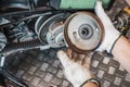 mechanic check auto Transmission system or Rear Clutch Pulley of scooter Motorcycles in garage. maintenance, repair motorcycle Royalty Free Stock Photo