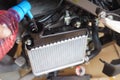 Mechanic Check water and Add water to motorcycle or scooter radiator in the garage, radiator is the main component of the cooling