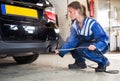 Mechanic, checking diesel exhaust emission rates Royalty Free Stock Photo