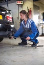 Mechanic checking diesel exhaust emission rates Royalty Free Stock Photo