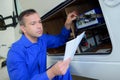 Mechanic checking electrics on campervan Royalty Free Stock Photo