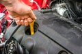 Mechanic checking the oil level in a car engine Royalty Free Stock Photo