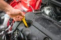 Mechanic checking the oil level in a car engine Royalty Free Stock Photo