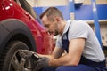 Mechanic Checking Pressure in Tires