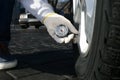 Mechanic checking tire air pressure at car service Royalty Free Stock Photo