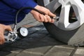 Mechanic checking tire air pressure at car service Royalty Free Stock Photo