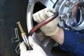Mechanic checking tire preasure Royalty Free Stock Photo