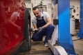 Mechanic Checking Tire Pressure in Auto Shop Royalty Free Stock Photo