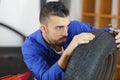 Mechanic checking tread depth on car tire