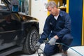 Mechanic Checking Tyre Pressure Royalty Free Stock Photo