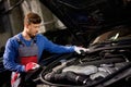 Mechanic checking under hood