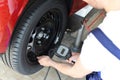 Mechanic checks air pressure from the car tyre in a garage Royalty Free Stock Photo