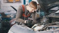 Mechanic checks and repairs automotive engine, car repair, working in the workshop, overhaul, under the hood