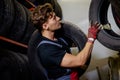 Mechanic choosing tires in a warehouse Royalty Free Stock Photo