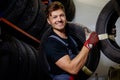 Mechanic choosing tires in a warehouse