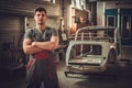 Mechanic in classic car restoration workshop Royalty Free Stock Photo