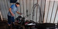 mechanic cleaning bajaj discover bike at service center in India aug 2019