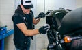 Mechanic cleaning a motorcycle