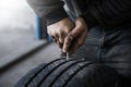 mechanic closes a hole in a tire in a workshop Royalty Free Stock Photo