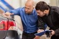 Mechanic and customer looking at car taillight Royalty Free Stock Photo