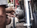 Mechanic dirty hands at work fixing an engine, intentional vintage colors