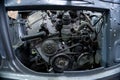 a mechanic disassembles an old dirty car engine on a red lift for repair and tuning turbo car Royalty Free Stock Photo